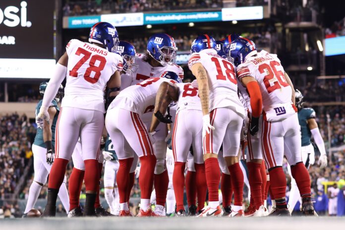 The New York Giants's offense huddles before a play against the Philadelphia Eagles.