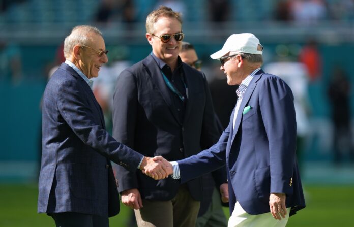 Miami Dolphins owner Stephan M. Ross (L) and chief executive officer Tom Garfinkel (C) meet with New York Jets owner Christoper Johnson (R).