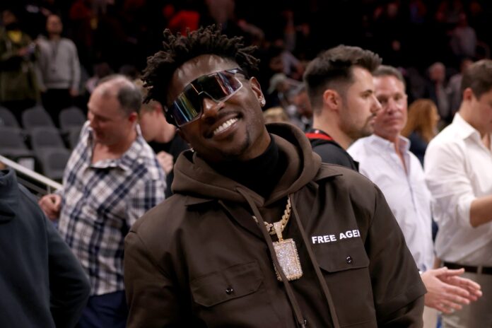 Antonio Brown poses for photographers after the game between the Atlanta Hawks and the LA Clippers at State Farm Arena.