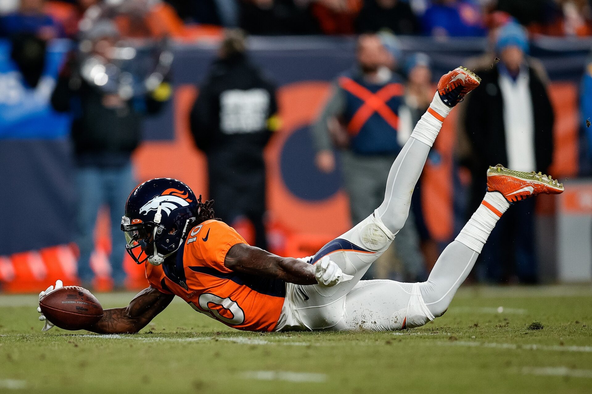 Jerry Jeudy (10) dives to recover a fumble in the fourth quarter against the Los Angeles Chargers at Empower Field at Mile High.