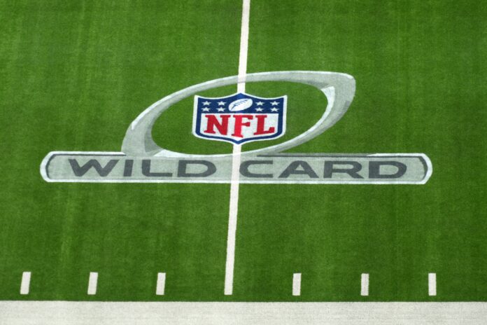 A NFL Wild Card playoff logo on the field at SoFi Stadium.