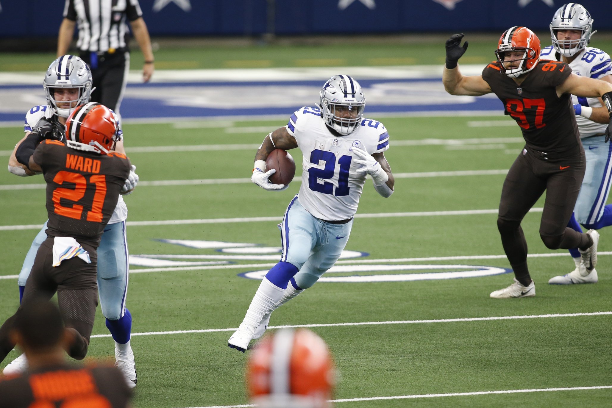 Dallas Cowboys running back Ezekiel Elliott (21) runs the ball in the second quarter against the Cleveland Browns at AT&T Stadium.