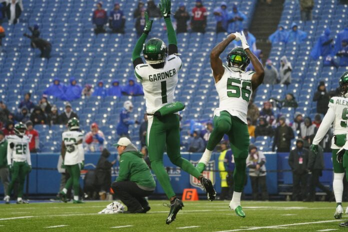 Sauce Gardner (1) and New York Jets linebacker Quincy Williams (56) warm up prior to the game against the Buffalo Bills at Highmark Stadium.