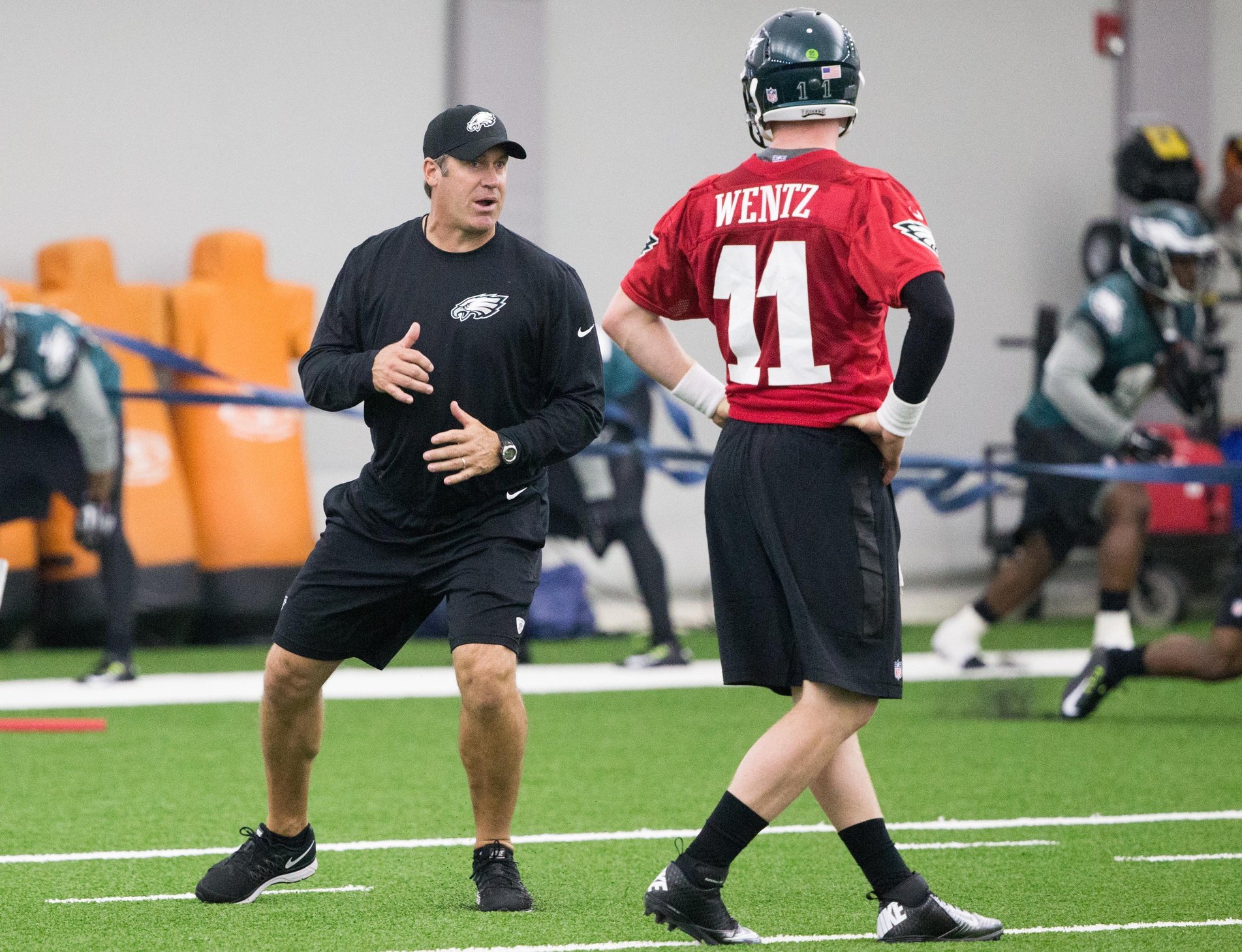 Former Philadelphia Eagles head coach (and current Jacksonville Jaguars head coach) Doug Peterson instructs former quarterback Carson Wentz (11) during Eagles rookie minicamp at the NovaCare Complex.