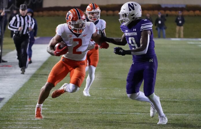 Running back Chase Brown (2) attempts to get past a Northwestern defender.
