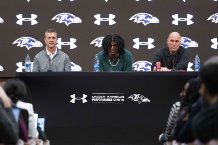 Baltimore Ravens head coach John Harbaugh, quarterback Lamar Jackson, and general manager Eric DeCosta listen to a question asked at a press conference at Under Armour Performance Center.