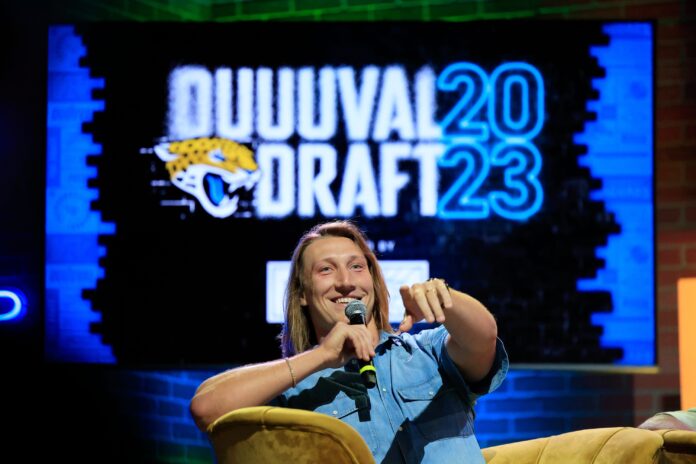 Trevor Lawrence points receiving help finding a fan who asked a question during an NFL Draft watch party.