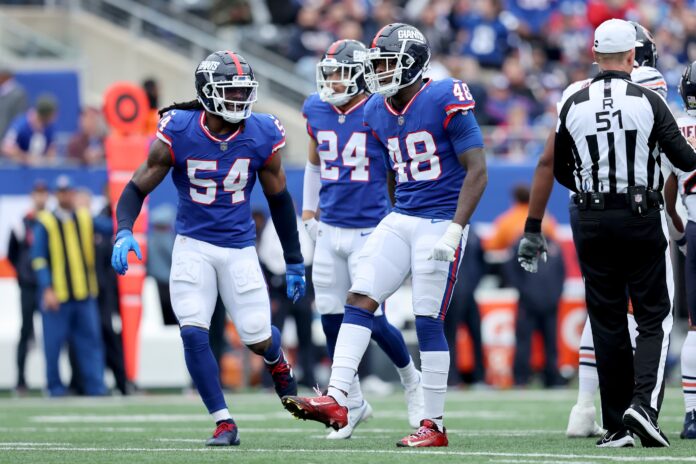 New York Giants linebacker Tae Crowder (48) celebrates his sack of Chicago Bears quarterback Justin Fields (not pictured) with linebacker Jaylon Smith (54) and safety Dane Belton (24) during the second quarter at MetLife Stadium.