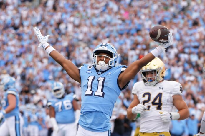 North Carolina Tar Heels wide receiver Josh Downs (11) reacts after scoring a touchdown in the second quarter at Kenan Memorial Stadium.