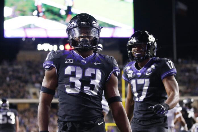 Kendre Miller (33) celebrate scoring a touchdown against the Kansas State Wildcats in the fourth quarter at Amon G. Carter Stadium.