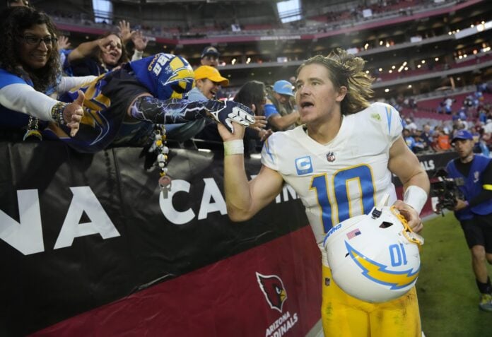 Los Angeles Chargers QB Justin Herbert (10) celebrates with fans after a win.