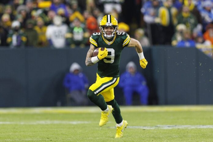 October 2, 2022: Green Bay Packers wide receiver Christian Watson (9)  scoring a touchdown during the NFL football game between the New England  Patriots and the Green Bay Packers at Lambeau Field