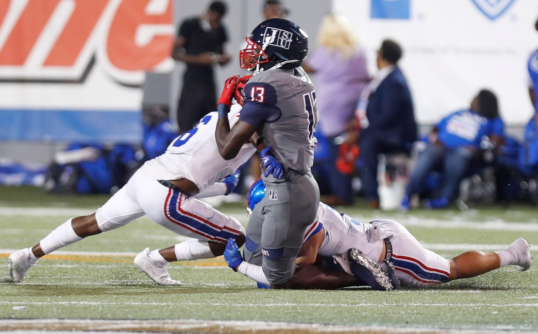 Jackson State WR Malachi Wideman (13) is tackled by a pair of Tennessee State players in the Southern Heritage Classic.