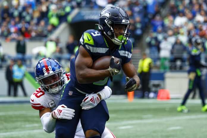 Julian Love (20) tackles Seattle Seahawks running back Kenneth Walker III (9) on a rushing attempt during the first quarter at Lumen Field.