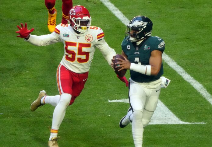 Jalen Hurts (1) throws a pass against Kansas City Chiefs defensive end Frank Clark (55) during the first quarter in Super Bowl LVII.