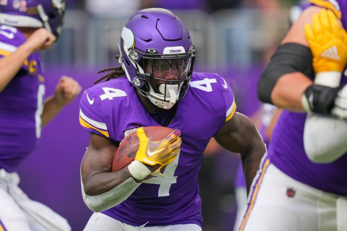 Dalvin Cook (4) runs with the ball against the Green Bay Packers in the first quarter at U.S. Bank Stadium.