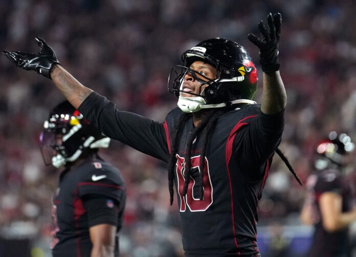 DeAndre Hopkins (10) gestures towards the crowd during their 42-34 win over the New Orleans Saints at State Farm Stadium.