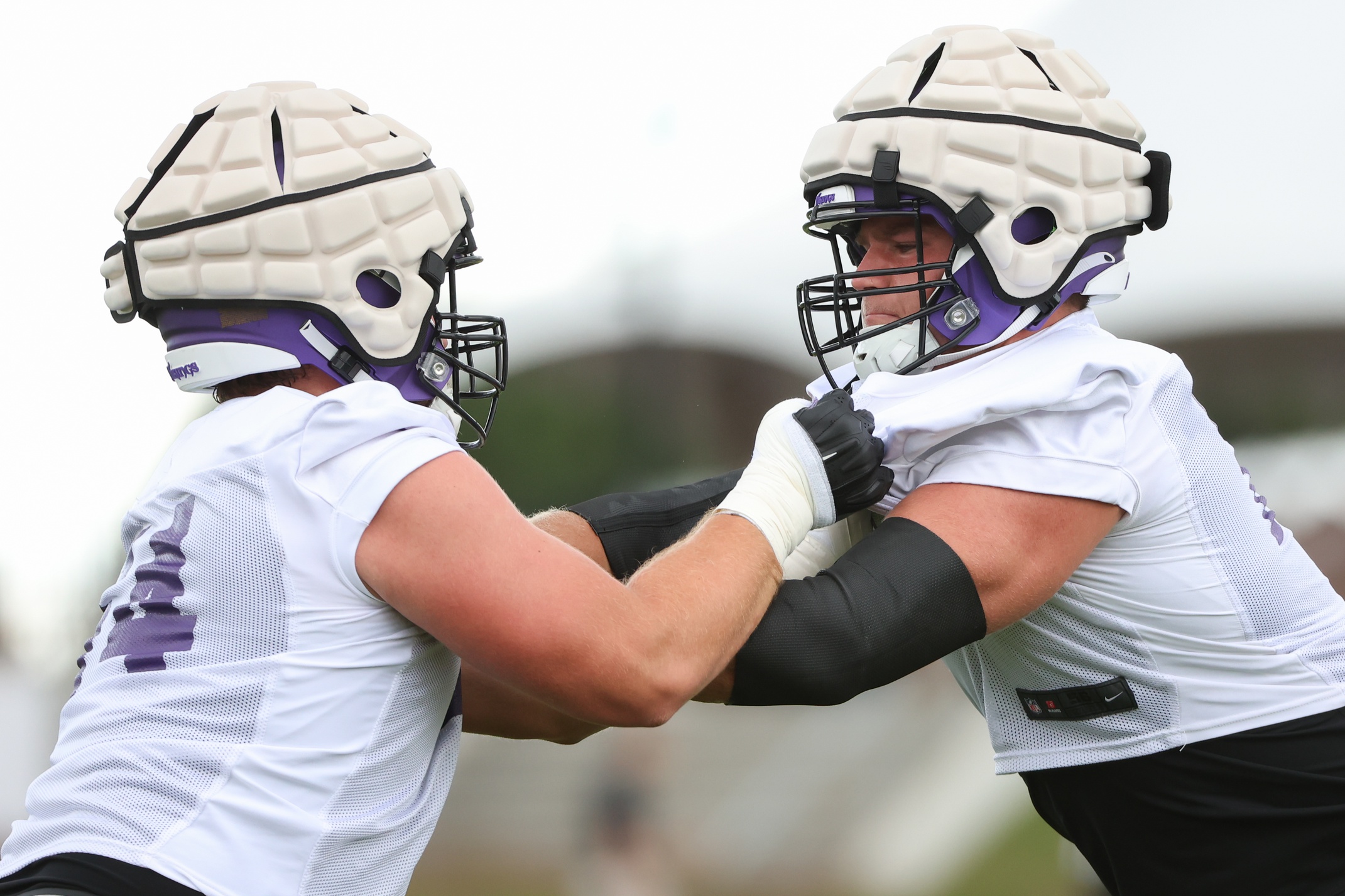 Brian O'Neill (75) and Blake Brandel (64) perform a drill during training camp at TCO Performance Center.