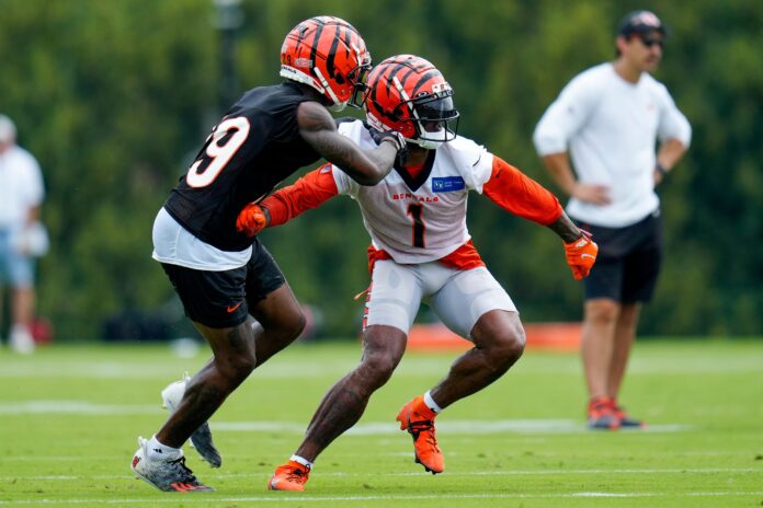 Cam Taylor-Britt (29) and Cincinnati Bengals wide receiver Ja'Marr Chase (1) run a play during a training camp practice at the Paycor Stadium practice field.