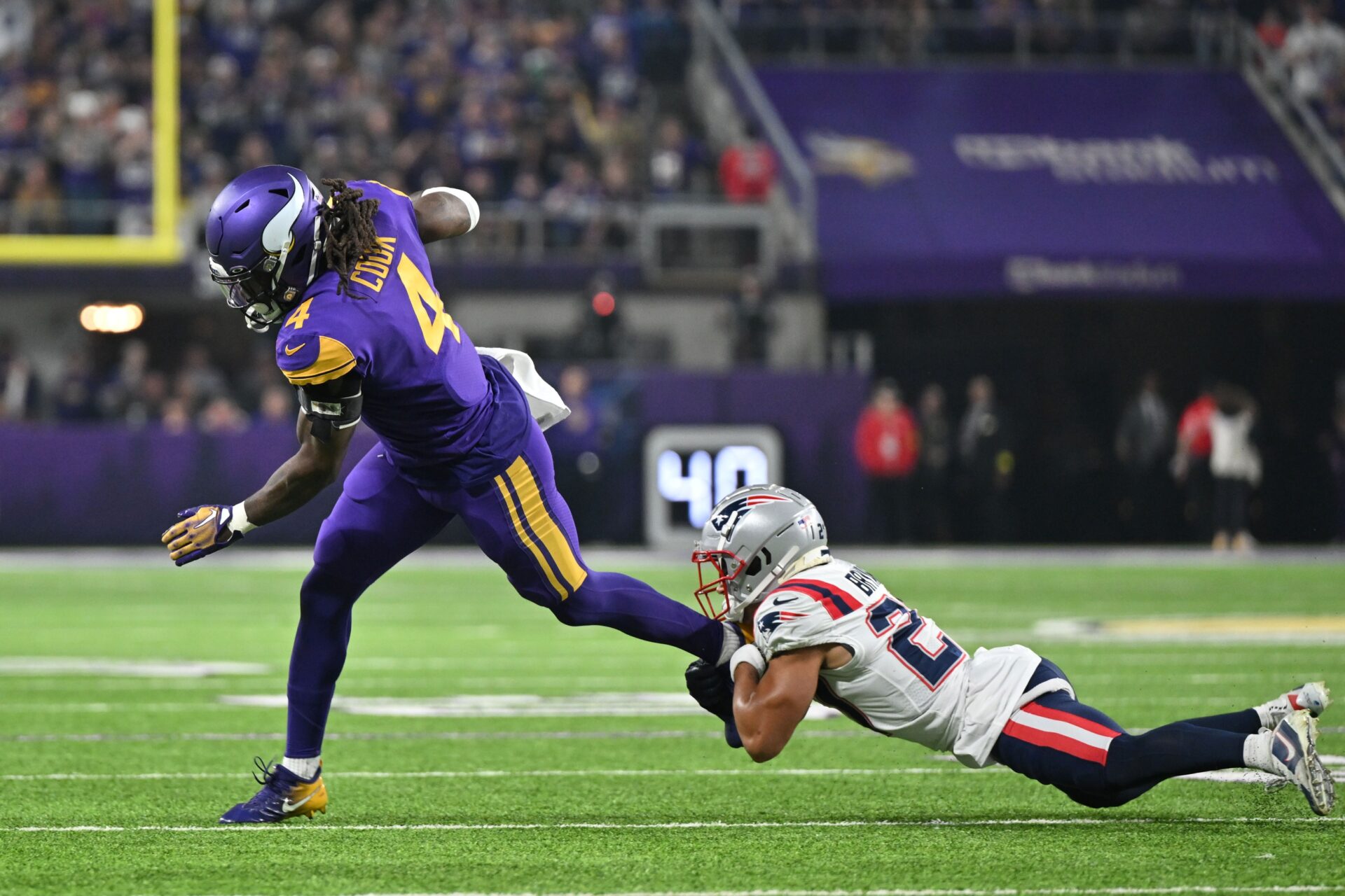 Minnesota Vikings RB Dalvin Cook (4) gets tackled by New England Patriots CB Myles Bryant (27).