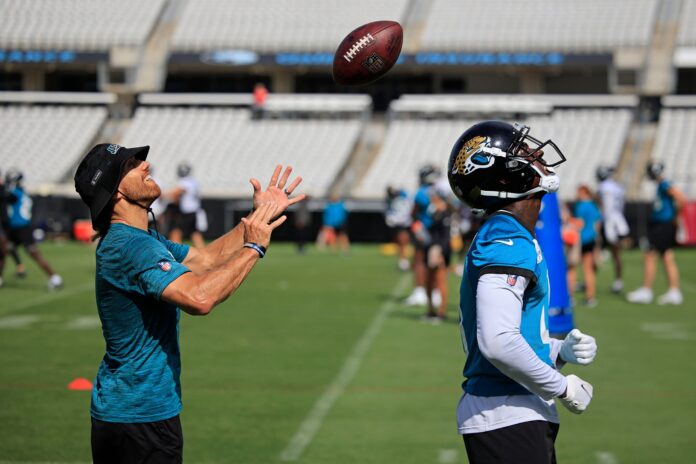 Jacksonville Jaguars wide receivers coach Chad Hall tosses a ball over the blind spot of WR Calvin Ridley (0) as part of training