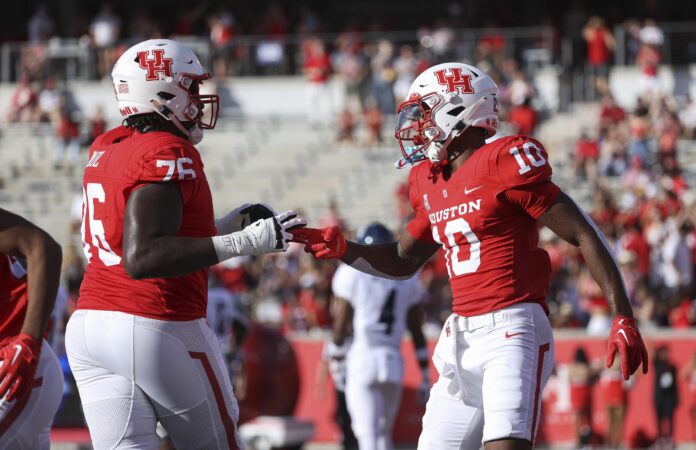 Houston Cougars WR Matthew Golden (10) and OT Patrick Paul (76) celebrate after a touchdown.