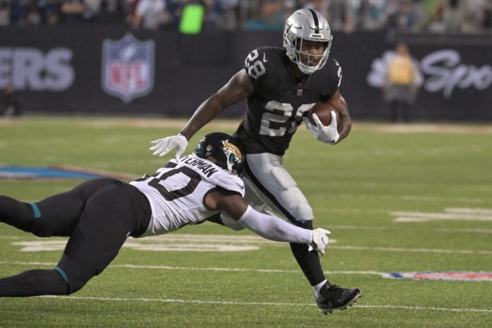 Las Vegas Raiders running back Josh Jacobs (28) walks off the