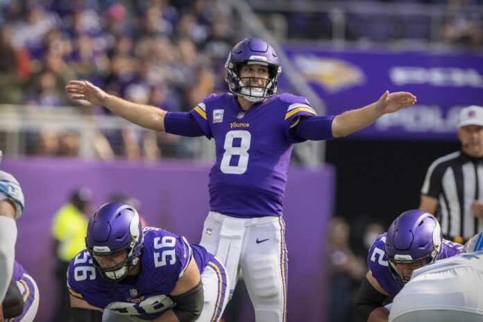 Kirk Cousins (8) sets the play against the Detroit Lions during the second quarter at U.S. Bank Stadium.