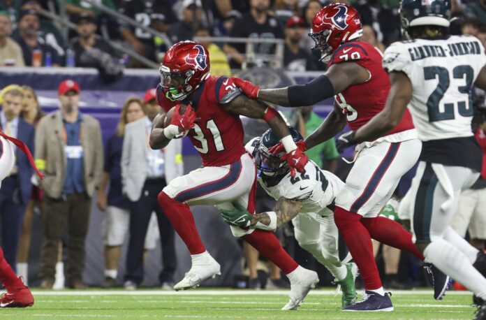 Houston Texans running back Dameon Pierce (31) runs with the ball as Philadelphia Eagles safety Marcus Epps (22) attempts to make a tackle during the second quarter at NRG Stadium.