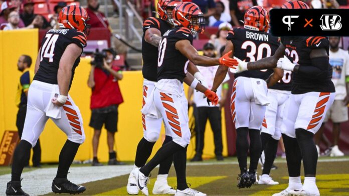 Cincinnati Bengals wide receiver Andrei Iosivas (80) is congratulated by teammates after scoring a touchdown against the Washington Commanders during the first half at FedExField.