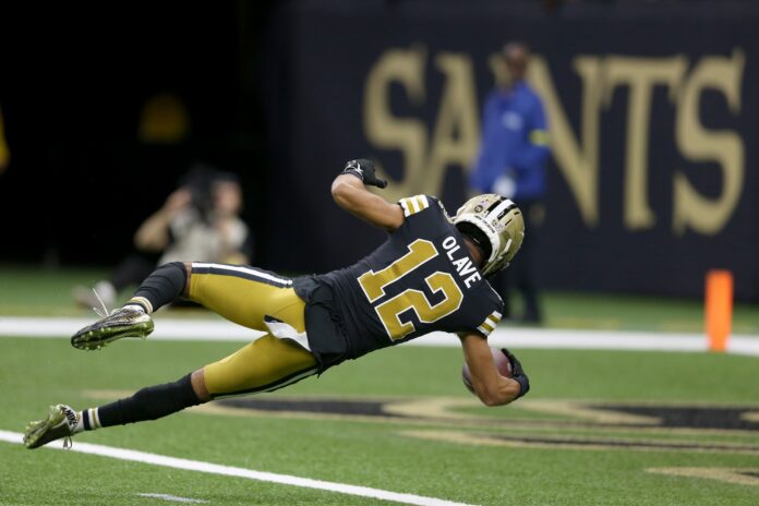 New Orleans Saints wide receiver Chris Olave (12) dives into the end zone for a touchdown in the second half against the Los Angeles Rams at the Caesars Superdome.