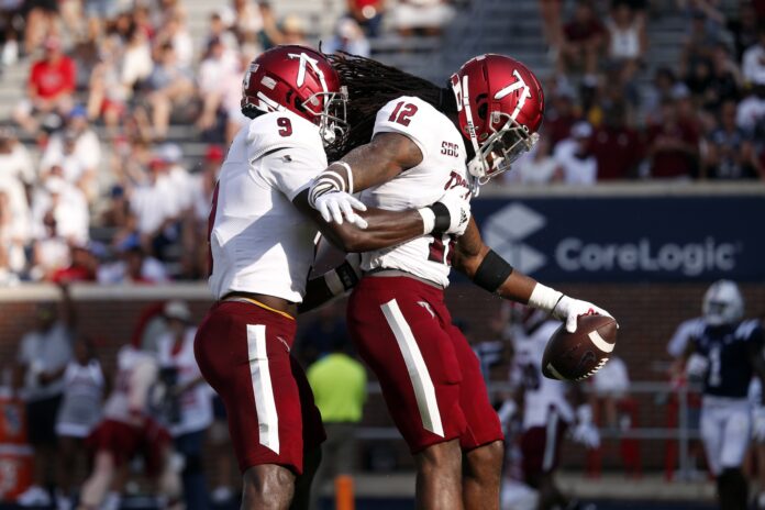 Richard Jibunor (10) celebrates with Troy Trojans defensive back Markeis Colvin (12) after a touchdown during the second half against the Mississippi Rebels at Vaught-Hemingway Stadium.