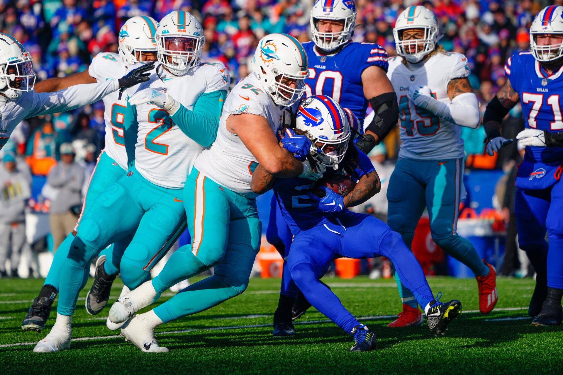 Miami Dolphins DT Zach Sieler (92) tackles Buffalo Bills RB James Cook (28).