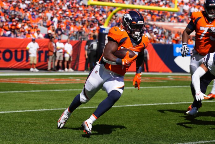Javonte Williams (33) carries the ball in the second half against the Houston Texans at Empower Field at Mile High.