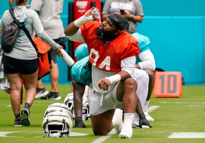 Miami Dolphins DT Christian Wilkins (94) drinks water during practice.
