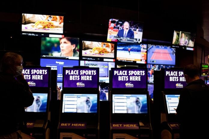 Customers place bets at kiosks in a casino.
