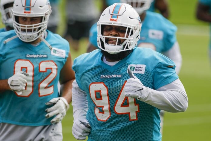 Miami Dolphins DT Christian Wilkins (94) jogs during training camp.
