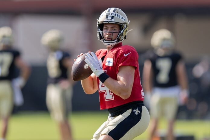 New Orleans Saints quarterback Jake Haener (14) runs through