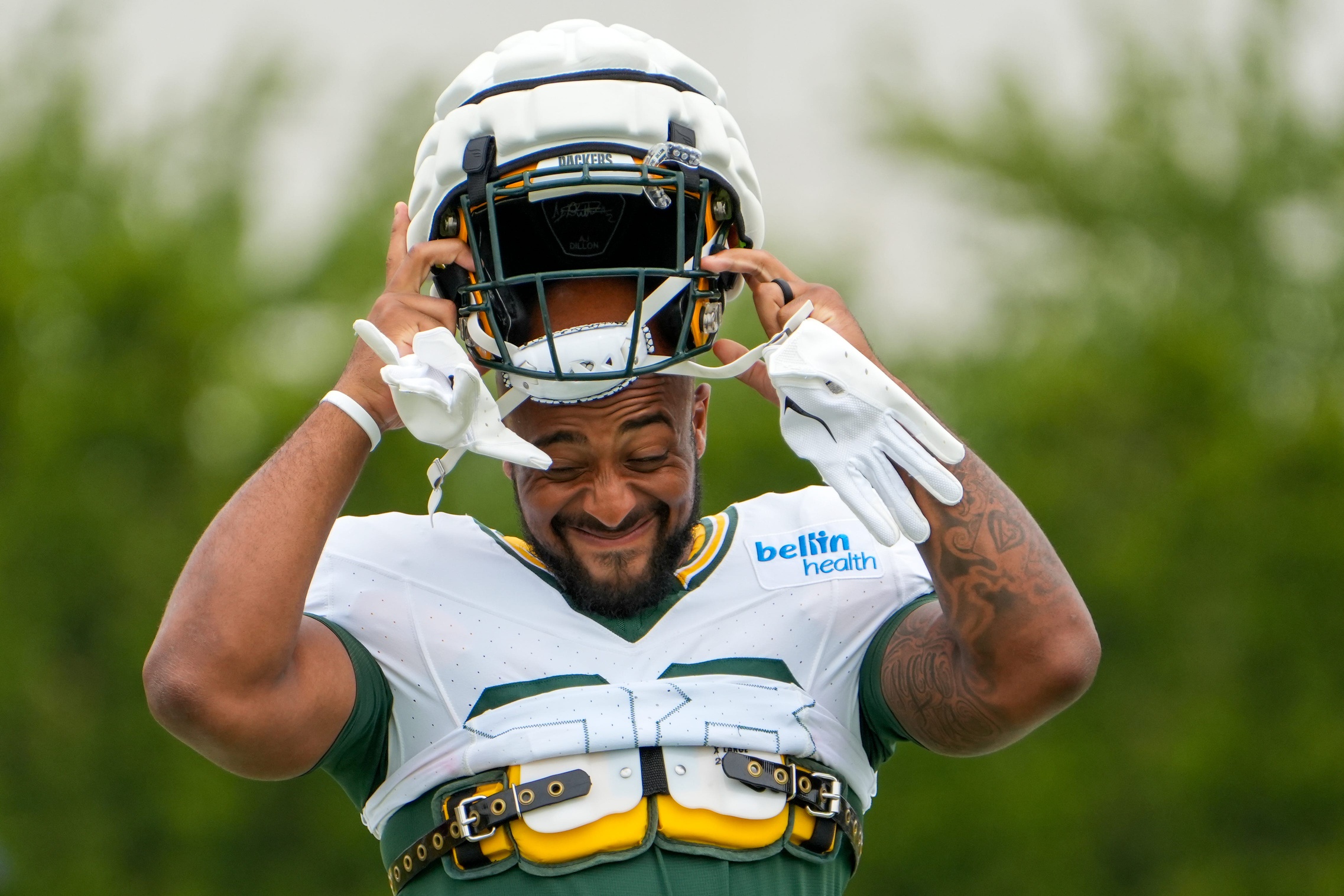 AJ Dillon (28) puts his helmet on during a joint practice between the Green Bay Packers and the Cincinnati Bengals.