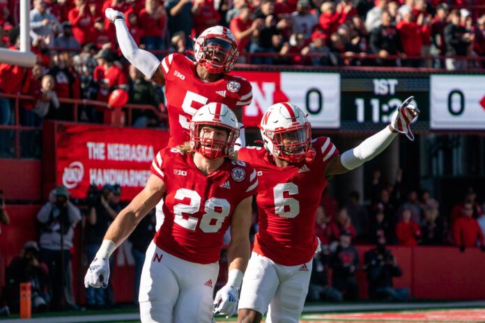 Nebraska Cornhuskers defensive players celebrate after a fourth-down stop.