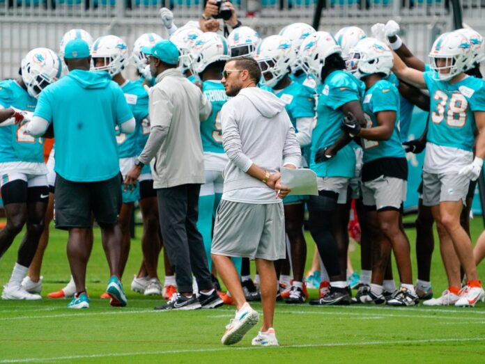 The Miami Dolphins huddle up during training camp.