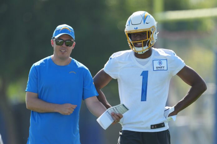 Los Angeles Chargers offensive coordinator Kellen Moore talks with wide receiver Quentin Johnston (1) during training camp.