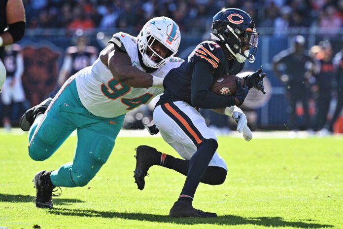 Miami Dolphins DT Christian Wilkins (94) tackles Chicago Bears WR Darnell Mooney (11).