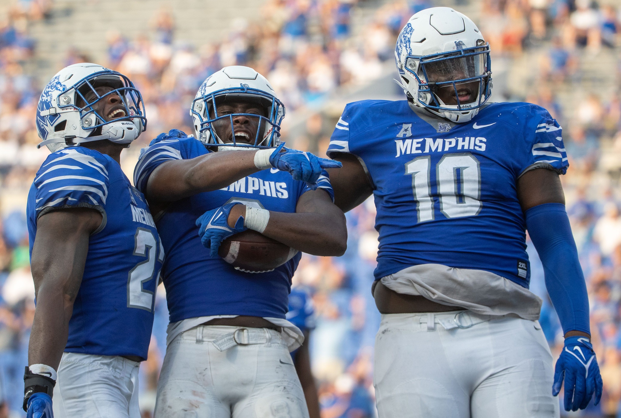 Jaylon Allen (22), defensive lineman Zy Brockington (0) and defensive lineman Cam'Ron Jackson (10) celebrate during a Memphis Tigers game against the North Texas Mean Green.