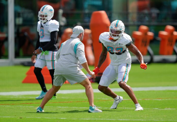 Miami Dolphins wide receivers coach Wes Welker works with Erik Ezukanma (87) during training camp.
