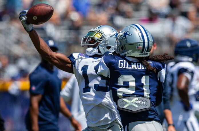 Michael Gallup (13) makes a catch against cornerback Stephon Gilmore (21) during training camp at Marriott Residence Inn-River Ridge playing fields.