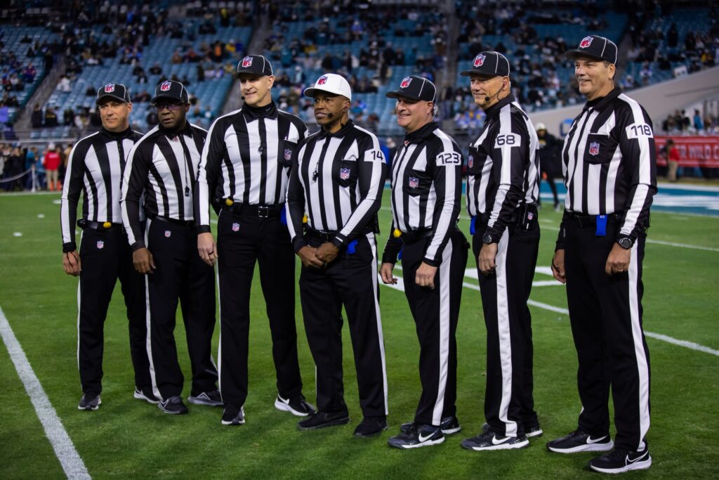 Officials pose before an NFL football game between the Los Angeles