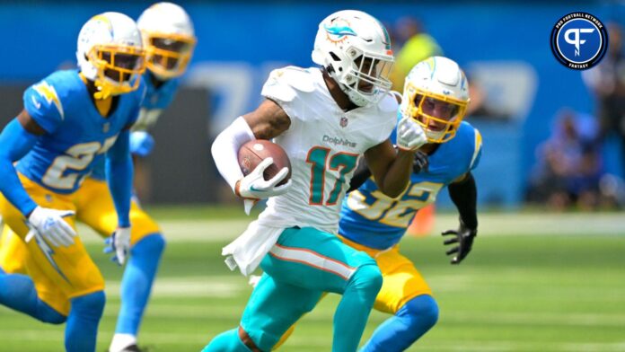 Miami Dolphins wide receiver Jaylen Waddle (17) is chased down by Los Angeles Chargers cornerback J.C. Jackson (27) and safety Alohi Gilman (32) after a pass play in the first half at SoFi Stadium.