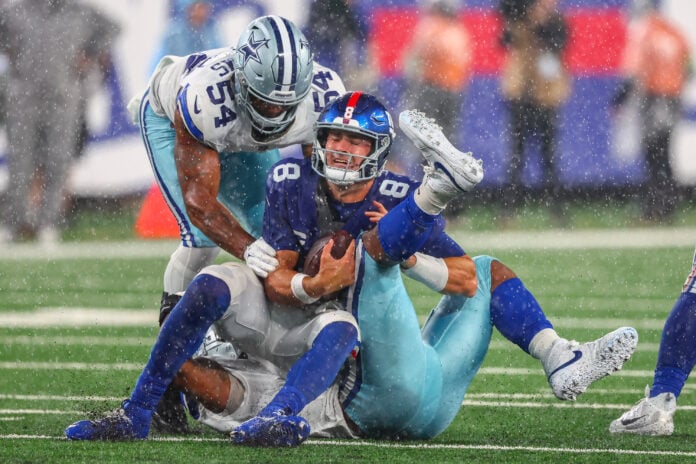 Sep 10, 2023; East Rutherford, New Jersey, USA; New York Giants quarterback Daniel Jones (8) is sacked by Dallas Cowboys linebacker Micah Parsons (11) during the second half at MetLife Stadium. Mandatory Credit: Ed Mulholland-USA TODAY Sports