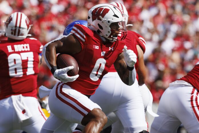Braelon Allen (0) rushes with the football during the first quarter against the Buffalo Bulls at Camp Randall Stadium.